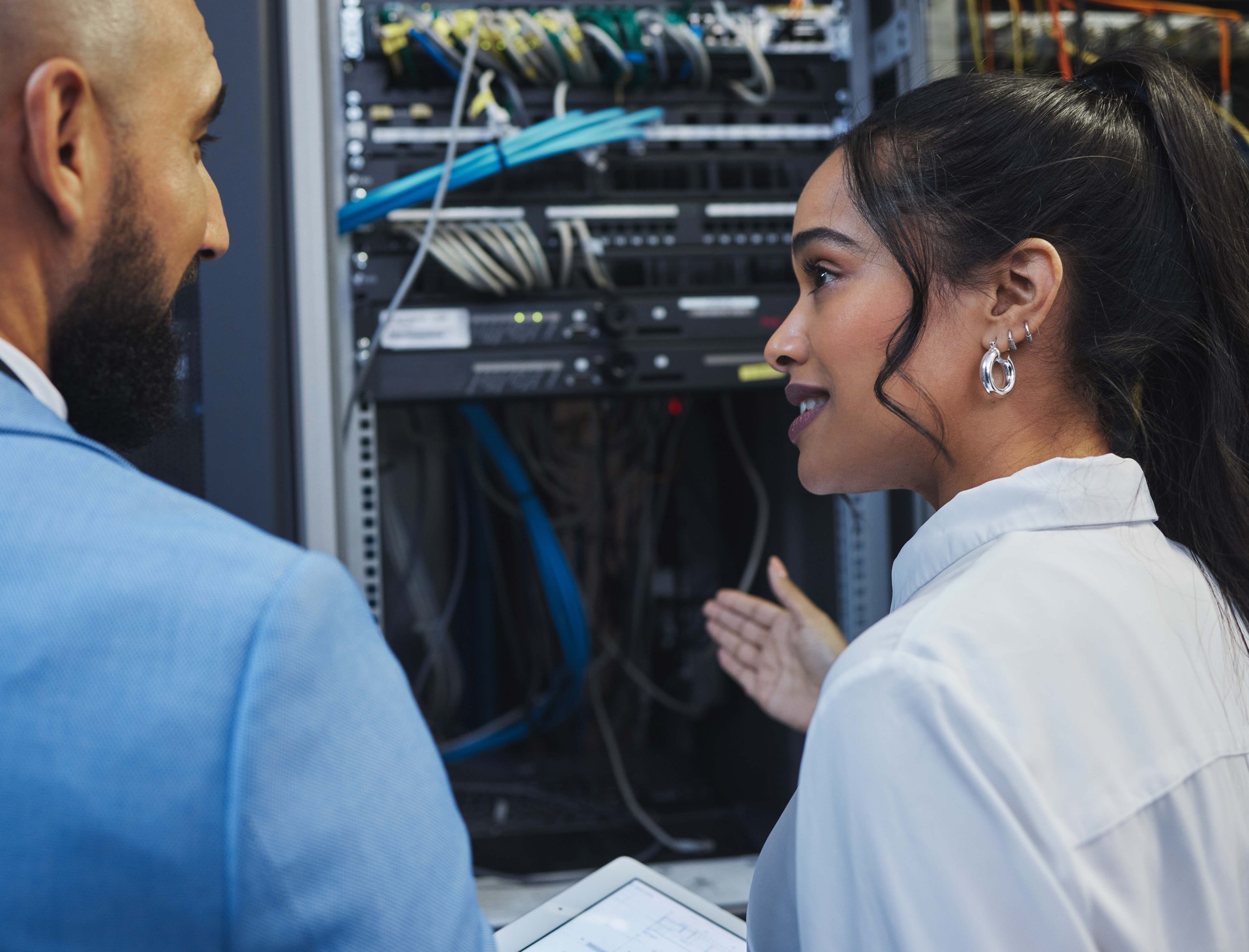 Shot of two workers inspecting the electronic equipment in a server room together at work