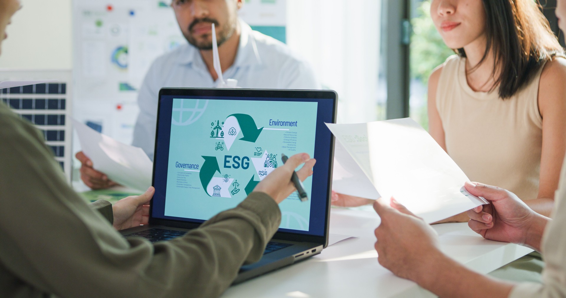 Closeup group Asia businesspeople talk ESG strategies risk management workshop, SDGs report, global warming, green finance and investment and net zero waste in boardroom training building.